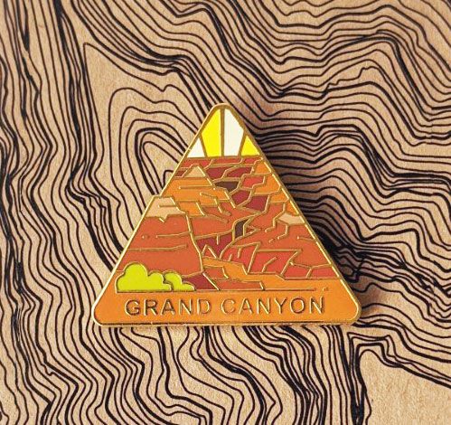 Triangle Grand Canyon national park enamel pin featuring a view of the canyon below.