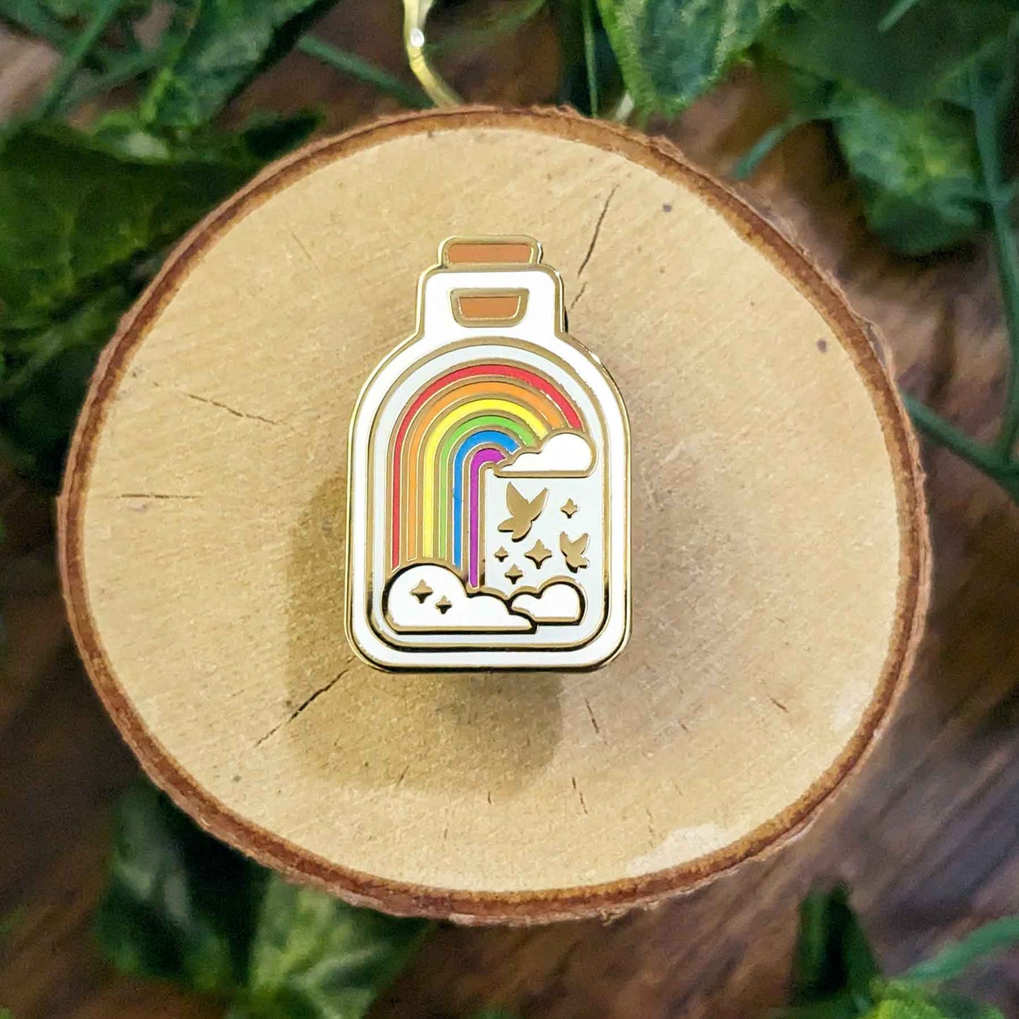 Classic rainbow with butterflies and clouds in a bottle enamel pin