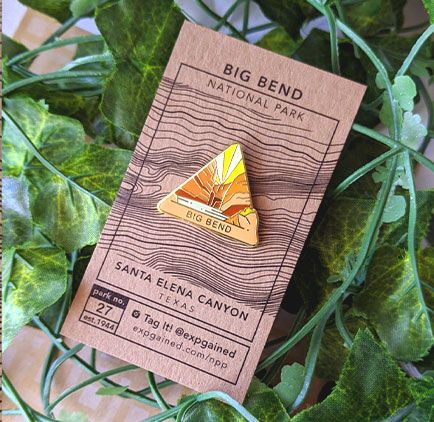 Triangle Big Bend national park enamel pin featuring a view from the beehive hike on a brown business card size backing card with a topo map of Santa Elena Canyon.