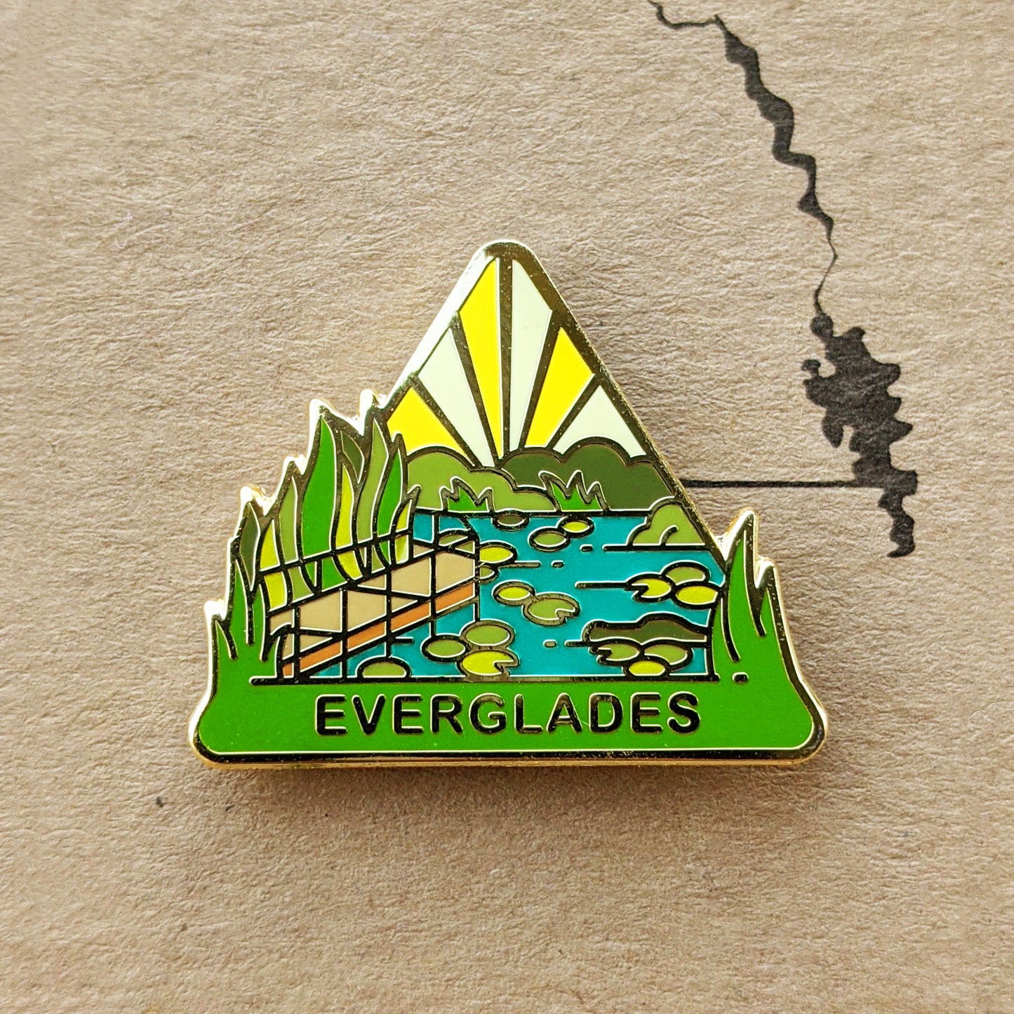 Triangle Everglades national park enamel pin featuring a view along the Anhinga Trail..