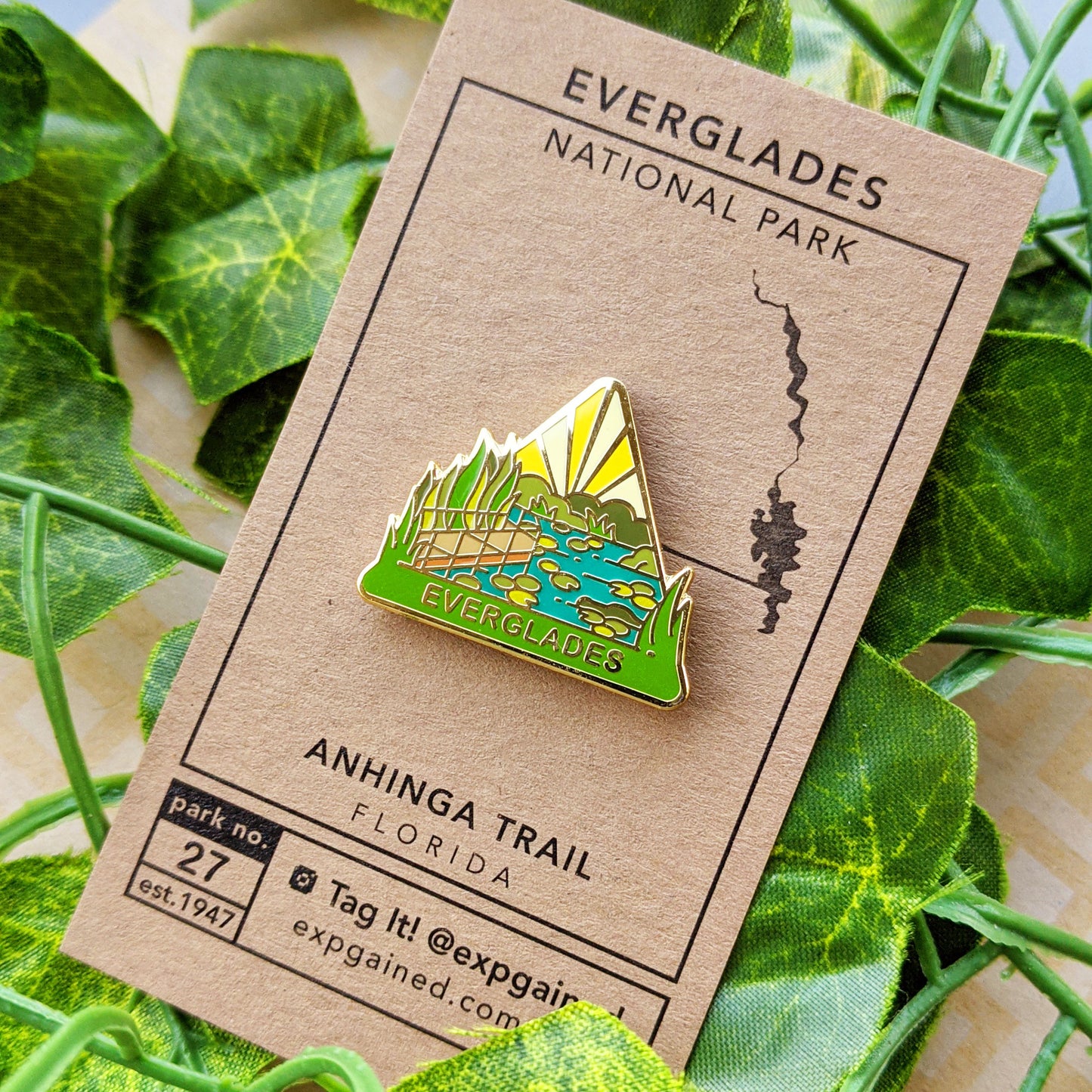 Triangle Everglades national park enamel pin featuring a view of the Anhinga Trail location..