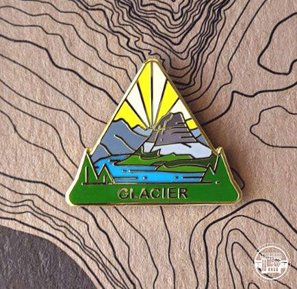 Triangle Glacier national park enamel pin featuring a view of Hidden Lake.