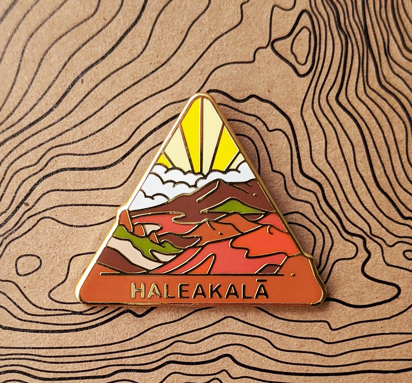 Triangle Haleakala national park enamel pin featuring a view of Haleakala's crater.