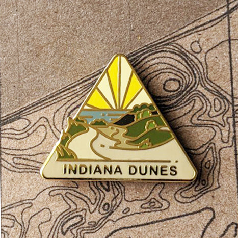 Triangle Indiana Dunes national park enamel pin featuring a view of sand dunes.