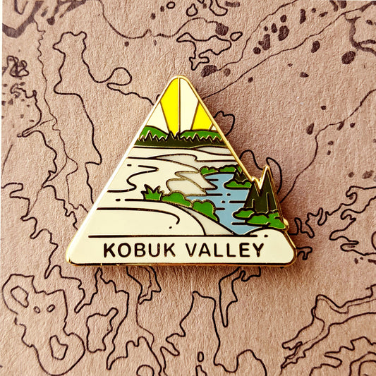 Triangle Kobuk Valley national park enamel pin featuring a view of Kobuk Sand Dunes.