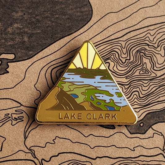 Triangle Lake Clark national park enamel pin featuring a view from Tanalian Mountain.